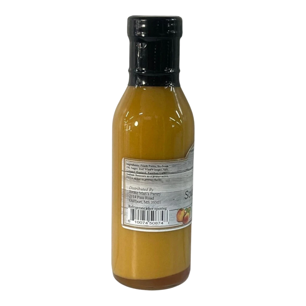 Broke Man's Pantry Southern Peach Dressing in a glass bottle with a black cap, featuring a sweet and tangy flavor.