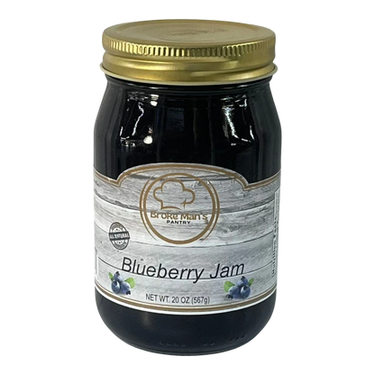 Broke Man's Pantry Blueberry Jam in a glass jar with a gold lid. All-natural jam with a smooth texture.