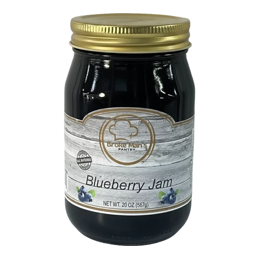 Broke Man's Pantry Blueberry Jam in a glass jar with a gold lid. All-natural ingredients, 20 oz.