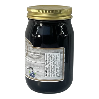 Broke Man's Pantry Blueberry Jam in a glass jar with a gold lid. The jam is dark purple and spreadable.