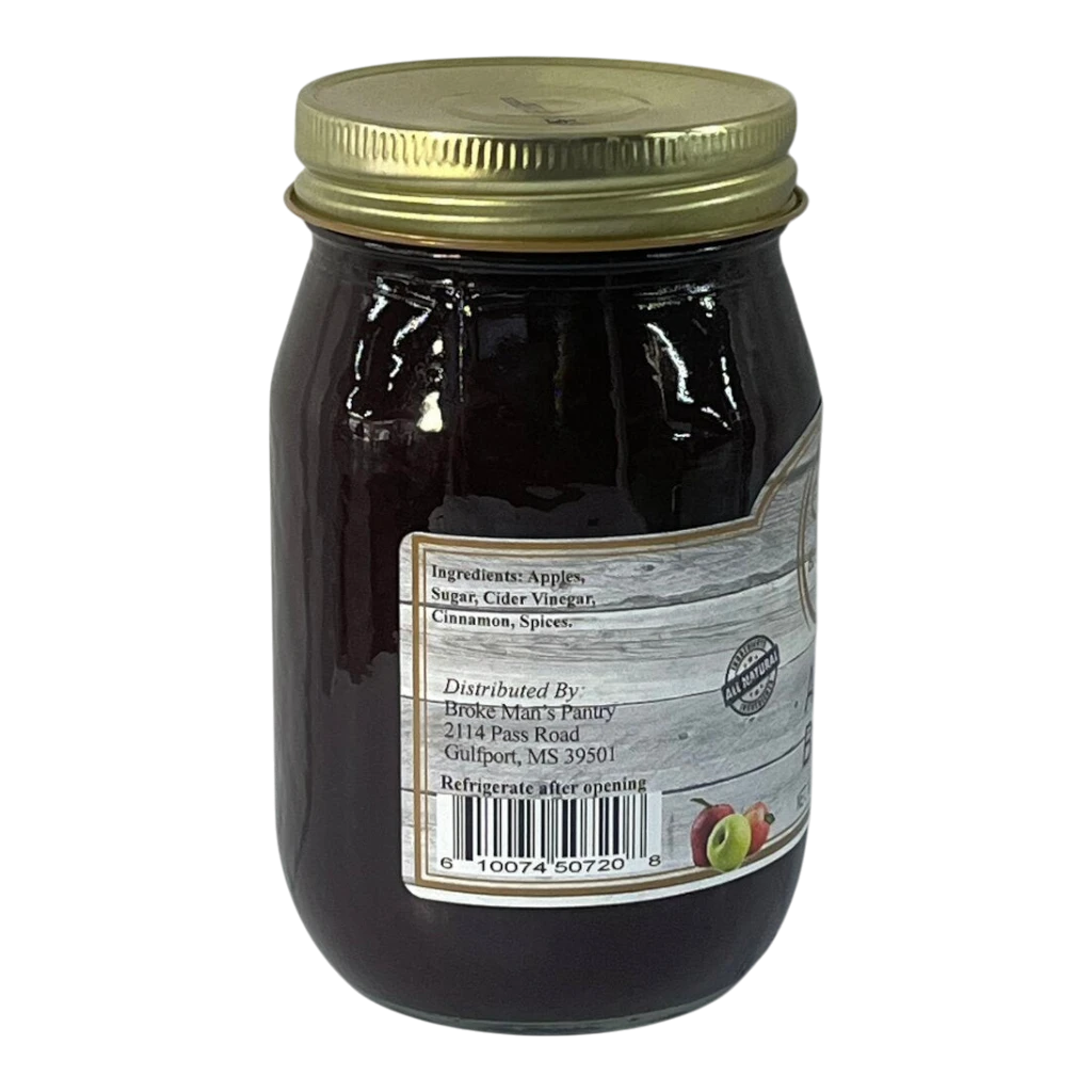 Broke Man's Pantry all-natural apple butter in a glass jar with a gold lid, featuring cinnamon and spice ingredients.
