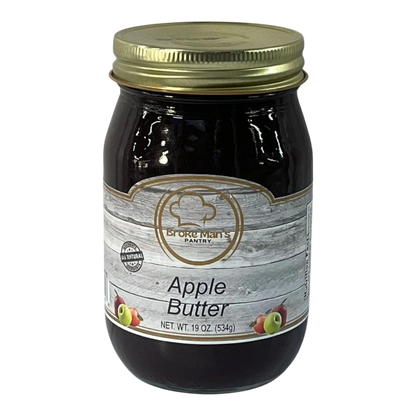 Broke Man's Pantry all-natural apple butter in a 19 oz glass jar with a rustic wood-grain label and gold lid.