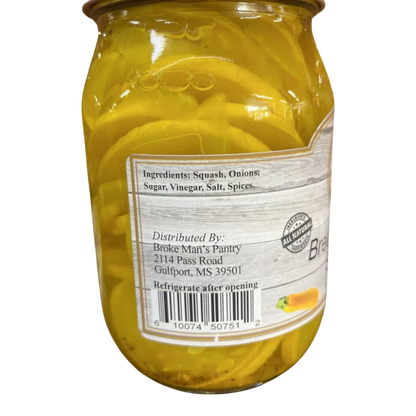 Broke Man's Pantry bread and butter squash in a glass jar with visible yellow squash slices and onion pieces.