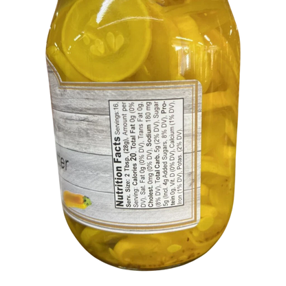 Broke Man's Pantry bread and butter squash in a glass jar with visible nutrition facts label and sliced yellow squash.