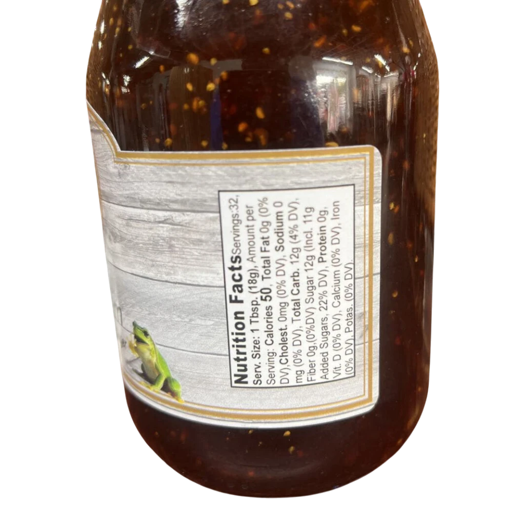 Broke Man's Pantry FROG Jam jar showing nutrition facts label with a small frog illustration on a wood-grain background
