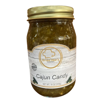 Broke Man's Pantry Jalapeño Cajun Candy in a glass jar with a gold lid, featuring a rustic label design.