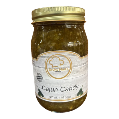 Broke Man's Pantry Jalapeño Cajun Candy in a glass jar with a gold lid, featuring a rustic label and green relish.