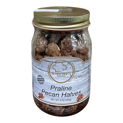 Broke Man's Pantry Praline Pecan Halves in a 9oz glass jar with a gold lid, featuring a rustic wood-grain label.