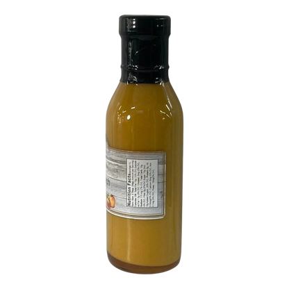 Broke Man's Pantry Southern Peach Dressing in a glass bottle with a black cap and nutrition label on a black background