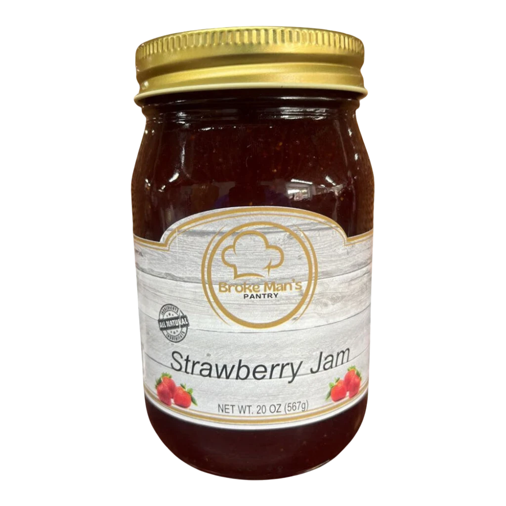 Broke Man's Pantry all-natural strawberry jam in a 20 oz glass jar with a gold lid on a wooden surface.