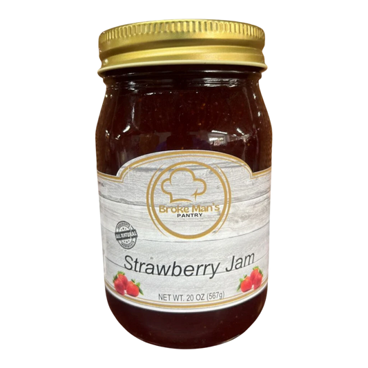 Broke Man's Pantry all-natural strawberry jam in a 20 oz glass jar with a gold lid on a wooden surface.
