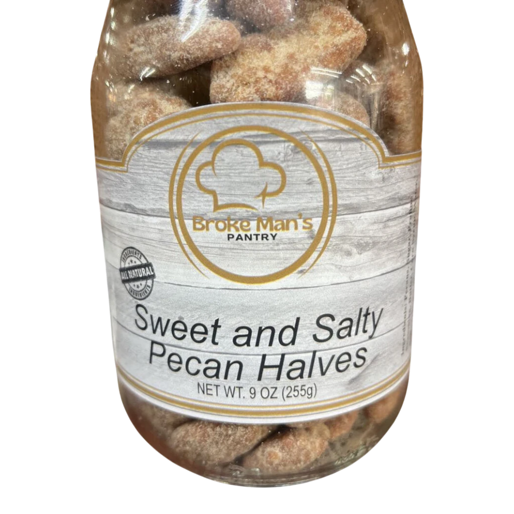 Broke Man's Pantry all-natural sweet and salty pecan halves in a 9 oz clear jar against a black background.