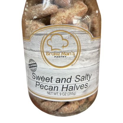 Broke Man's Pantry all-natural sweet and salty pecan halves in a 9 oz clear jar against a black background.