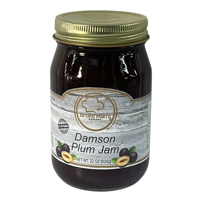 Broke Man's Pantry Damson Plum Jam in a 22 oz glass jar with a gold lid and rustic wood-grain label design.