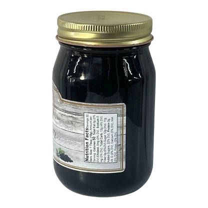 Broke Man's Pantry deep purple elderberry jelly in a glass jar with a gold lid and nutrition facts label.