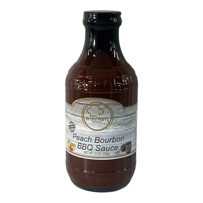 Broke Man's Pantry Peach Bourbon BBQ sauce in a 19 oz bottle with a rustic label featuring peach and barrel graphics.