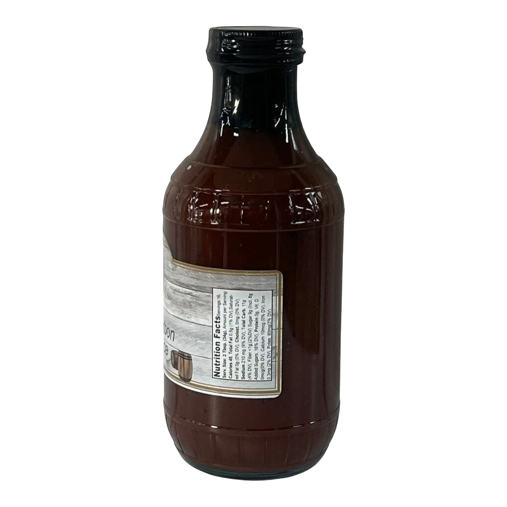 Broke Man's Pantry Peach Bourbon BBQ sauce in a glass bottle with a nutrition facts label, isolated on black.