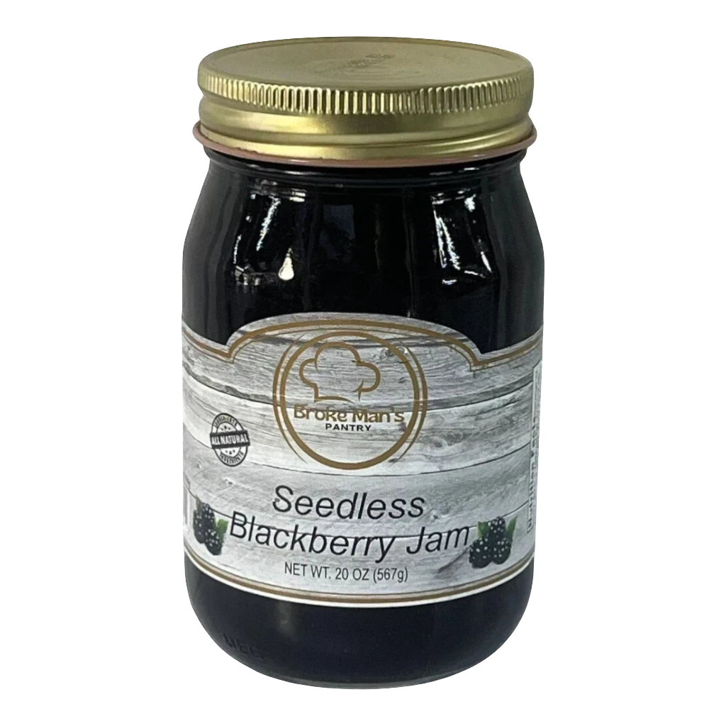 Broke Man's Pantry seedless blackberry jam in a 20 oz glass jar with a gold lid and rustic wood-grain label.