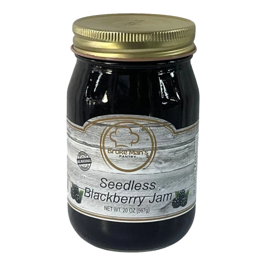 Broke Man's Pantry seedless blackberry jam in a 20 oz glass jar with a gold lid and rustic wood-grain label.