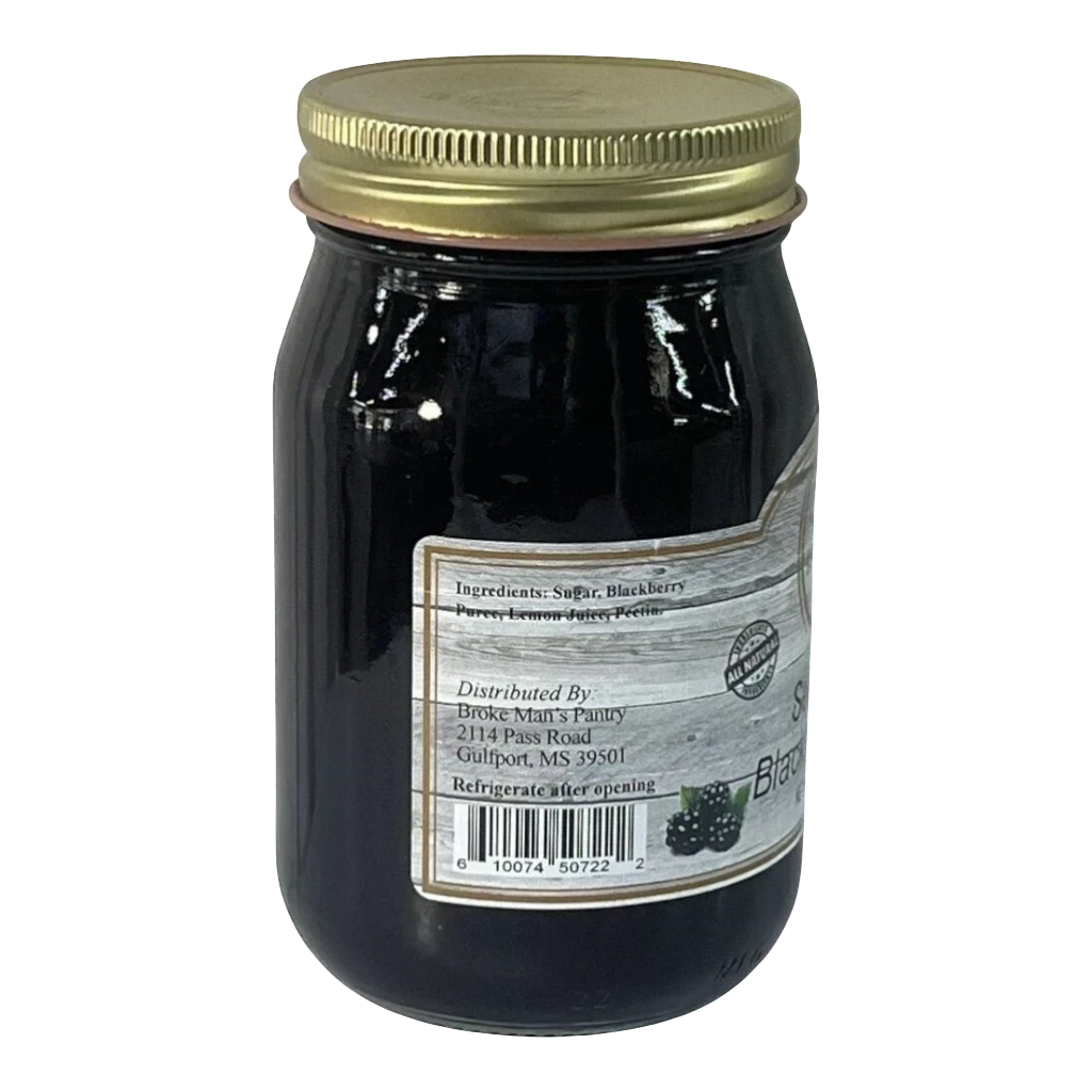Broke Man's Pantry seedless blackberry jam in a glass jar with a gold lid, featuring a rustic label design.