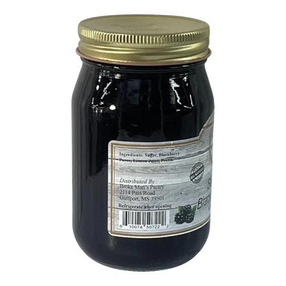 Broke Man's Pantry seedless blackberry jam in a glass jar with a gold lid, featuring a rustic label design.