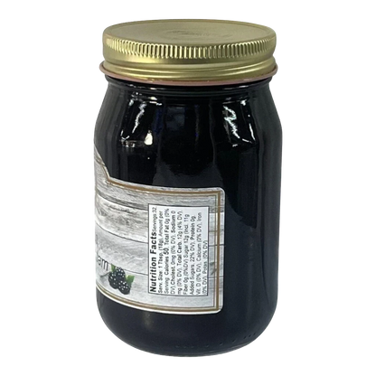 Broke Man's Pantry seedless blackberry jam in a glass jar with a gold lid, showing nutrition facts label.