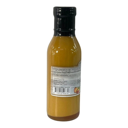 Broke Man's Pantry Southern Peach Dressing in a glass bottle with a black cap, featuring a sweet and tangy flavor.