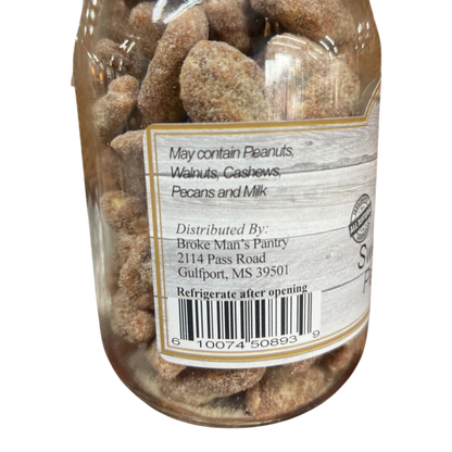 Broke Man's Pantry sweet and salty pecan halves in a clear jar with a rustic wood-grain label